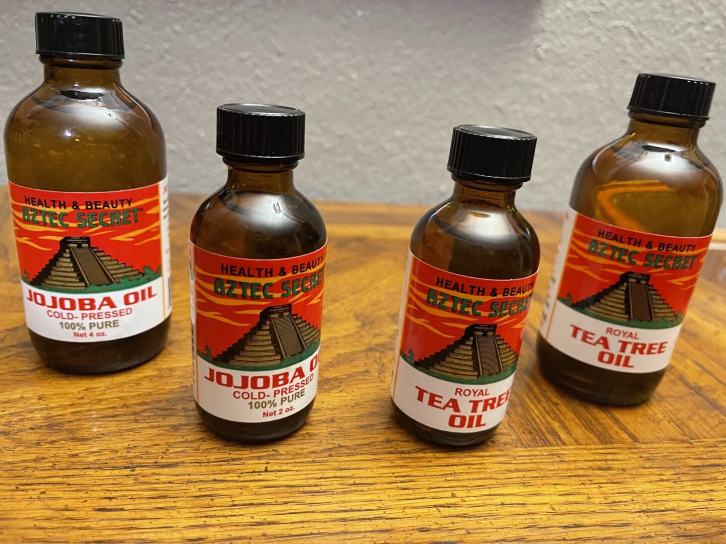 Bottles of our jojoba oil and tea tree oil products | Aztec Secret Health & Beauty LTD