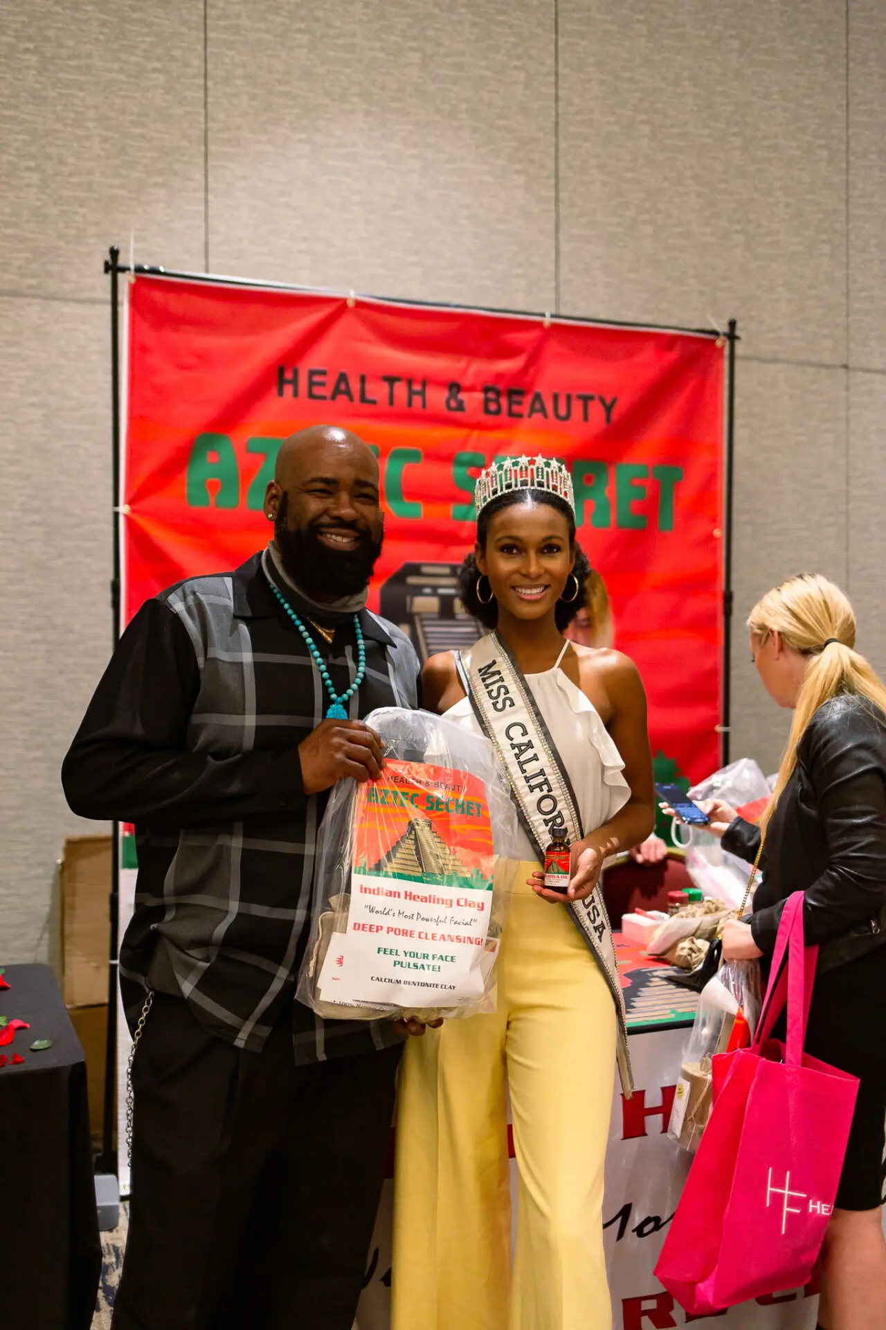 A man posing with Miss California