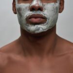 Face,Closeup,Of,Shirtless,Young,African,American,Man,Using,Facial