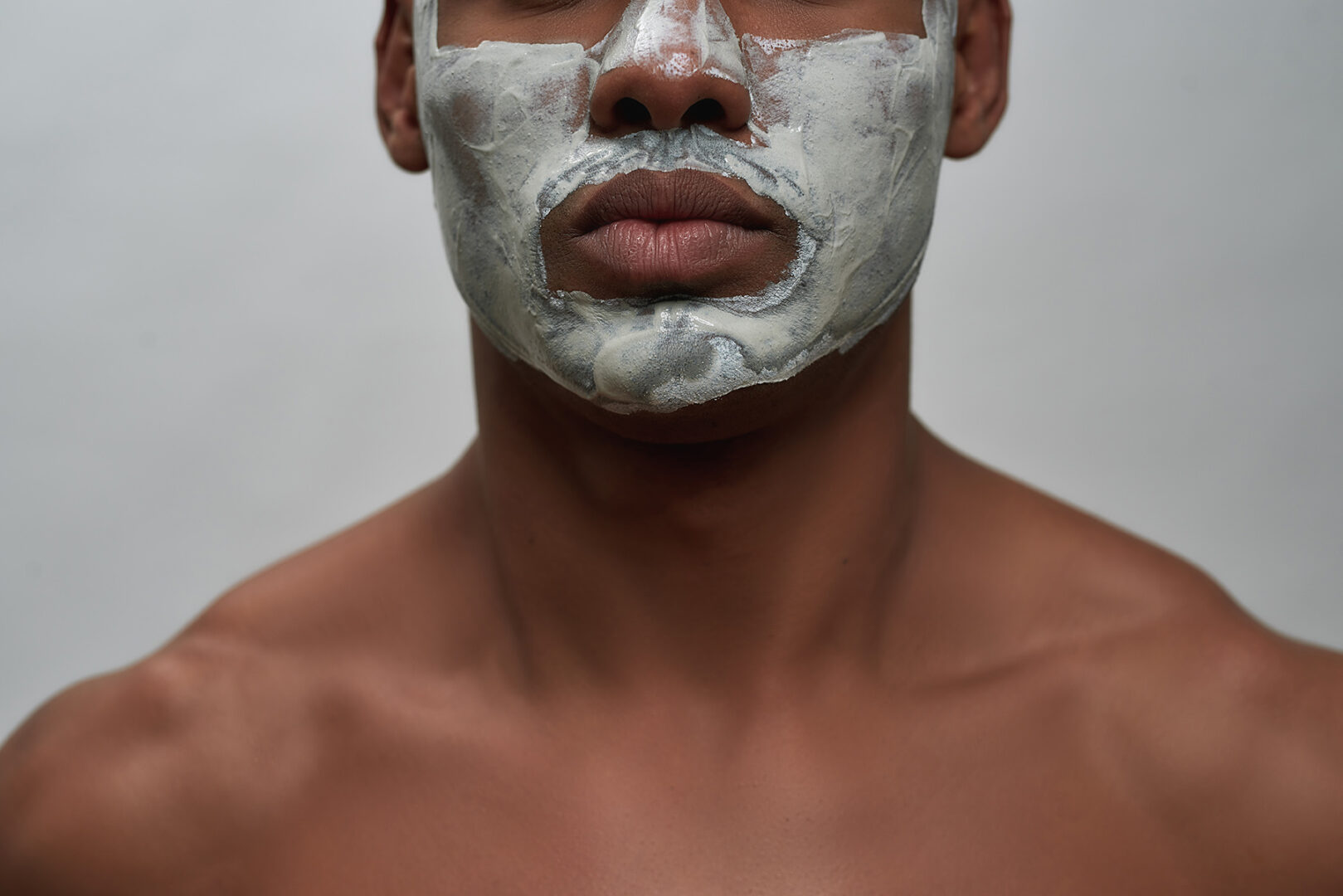 Face,Closeup,Of,Shirtless,Young,African,American,Man,Using,Facial